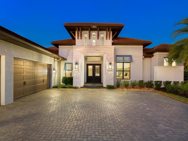 entrance to property featuring french doors and a garage