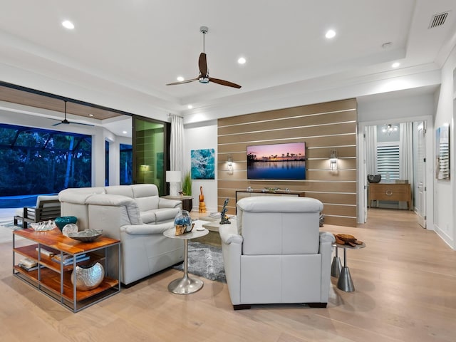 living room with ceiling fan and light hardwood / wood-style floors