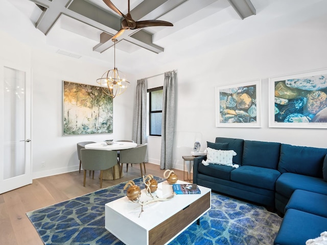 living room with beam ceiling, wood-type flooring, and ceiling fan with notable chandelier