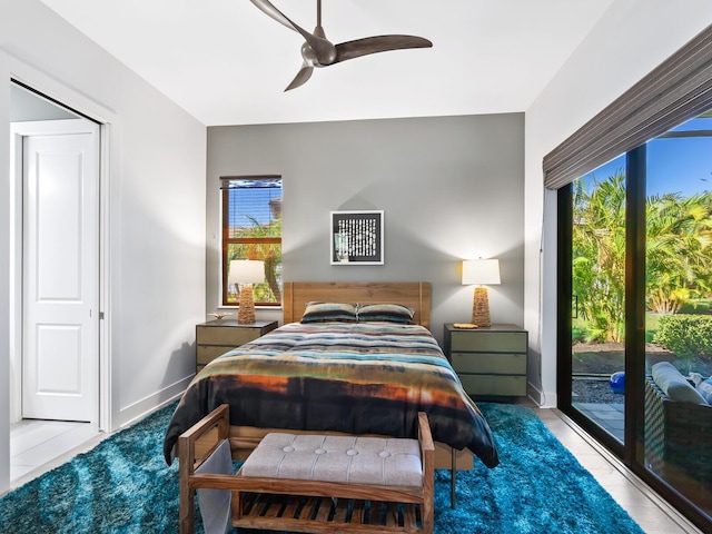 bedroom with ceiling fan and access to exterior