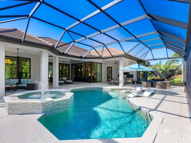 view of swimming pool with glass enclosure, ceiling fan, an outdoor hangout area, pool water feature, and a patio