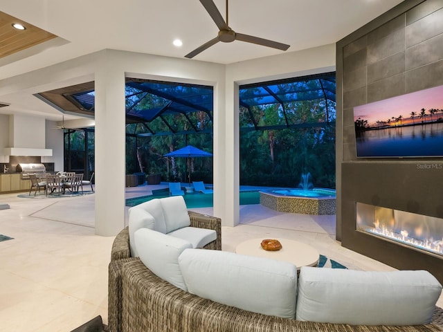 view of patio / terrace featuring grilling area, ceiling fan, and an outdoor kitchen