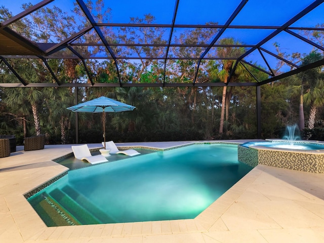 view of swimming pool featuring glass enclosure, a patio area, and an in ground hot tub