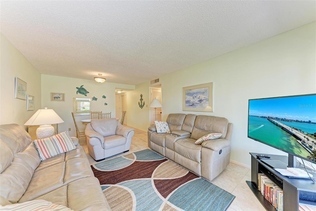 living room featuring light tile patterned floors and a textured ceiling