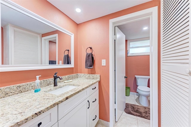 bathroom featuring tile patterned floors, vanity, and toilet