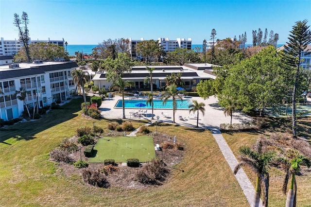 view of swimming pool featuring a patio area and a yard