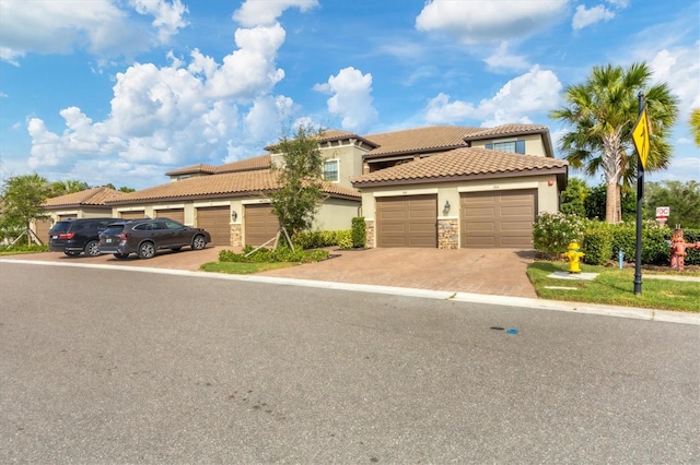 mediterranean / spanish home featuring a garage