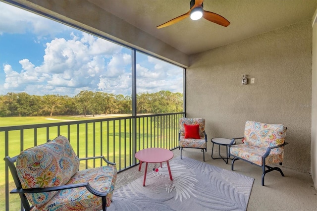 sunroom featuring ceiling fan