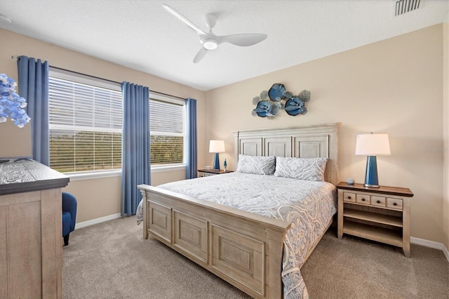 bedroom featuring light carpet and ceiling fan