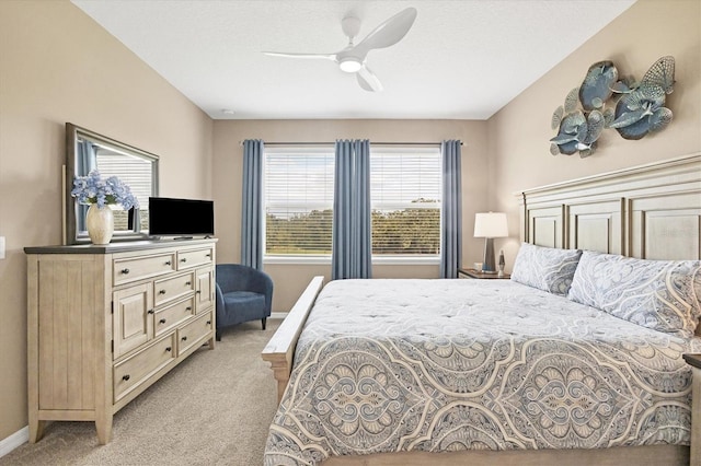 bedroom with ceiling fan and light carpet