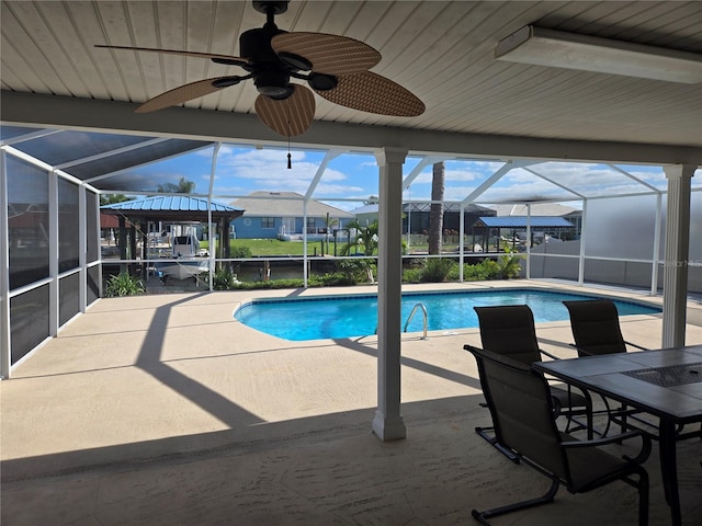 view of swimming pool featuring a lanai, a patio area, and ceiling fan