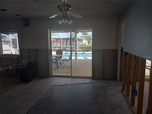 interior space with ceiling fan