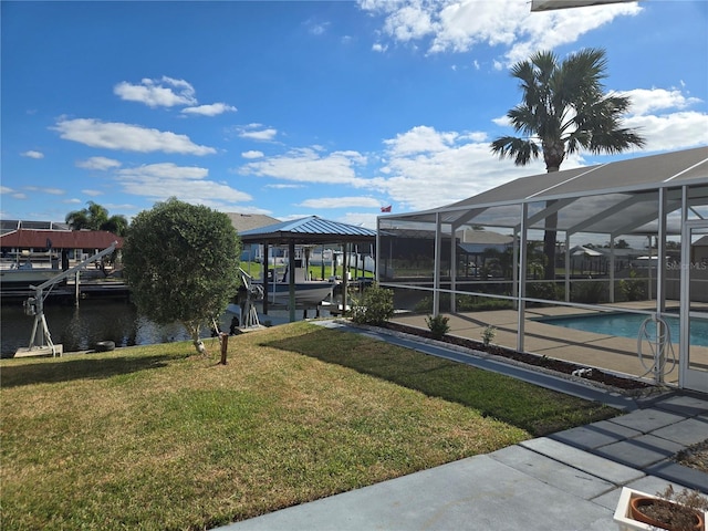 view of yard featuring glass enclosure and a water view