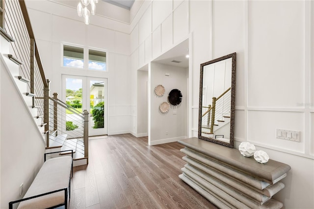 931 Bayshore Rd, Nokomis, FL 34275 - foyer entrance with stairs, wood finished floors, a high ceiling, and baseboards