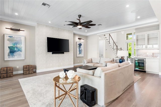 living room with light hardwood / wood-style floors, wine cooler, ceiling fan, and wooden ceiling