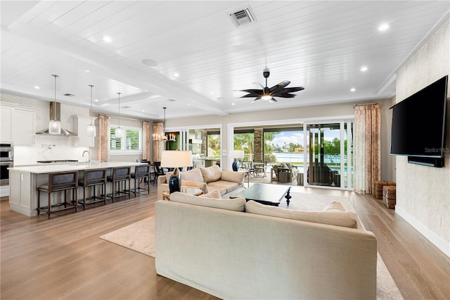 931 Bayshore Rd, Nokomis, FL 34275 - living area featuring light wood-style flooring, recessed lighting, a ceiling fan, baseboards, and wood ceiling with exposed beams