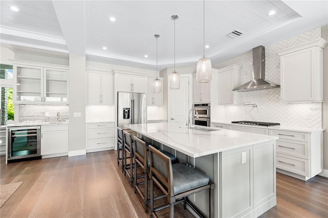 931 Bayshore Rd, Nokomis, FL 34275 - kitchen with wine cooler, wall chimney range hood, stainless steel appliances, dark wood-style floors, and a sink