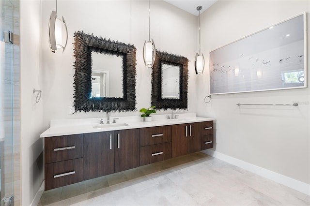 931 Bayshore Rd, Nokomis, FL 34275 - full bathroom with baseboards, double vanity, and a shower with shower door