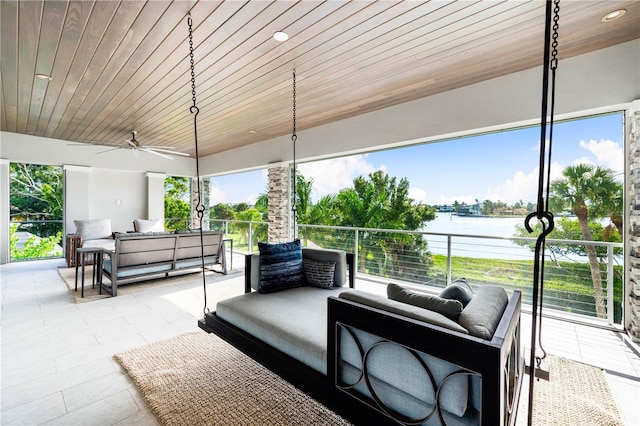 view of patio / terrace featuring outdoor lounge area, a water view, ceiling fan, and a balcony