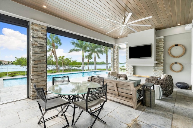 931 Bayshore Rd, Nokomis, FL 34275 - view of patio featuring a ceiling fan, an outdoor living space with a fireplace, and outdoor dining area