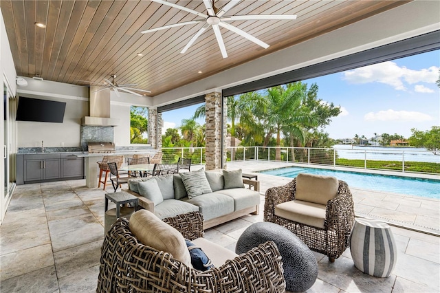 view of patio with outdoor lounge area, ceiling fan, a grill, area for grilling, and a water view