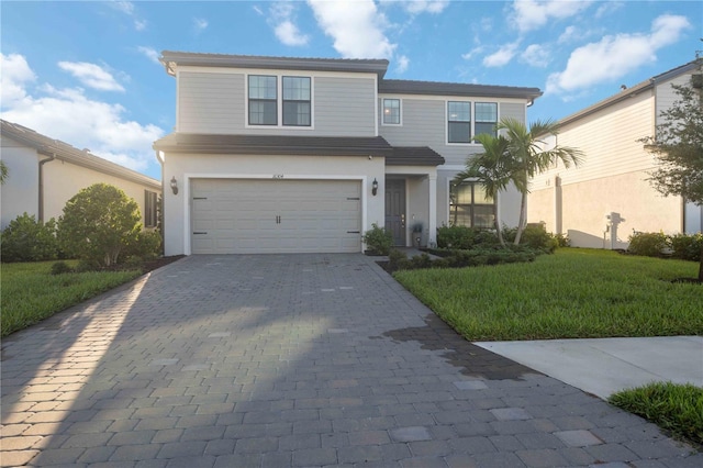 view of front facade with a garage and a front lawn