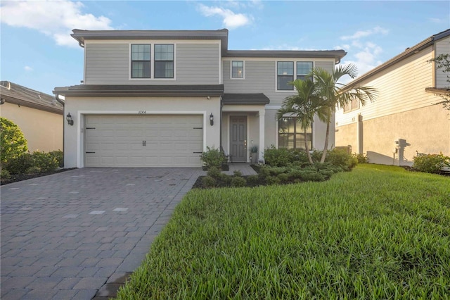 view of front property with a garage and a front yard