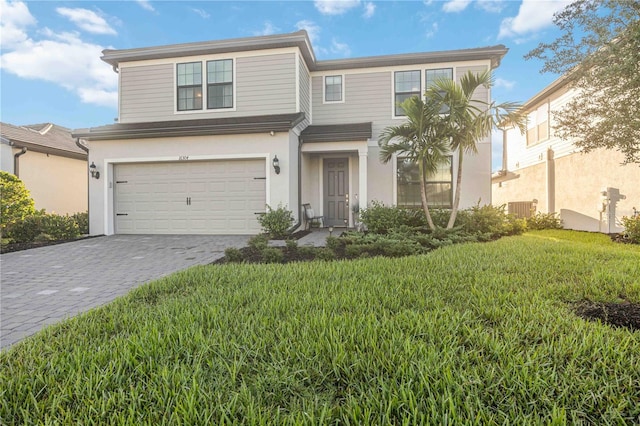 view of front of home featuring a garage and a front lawn