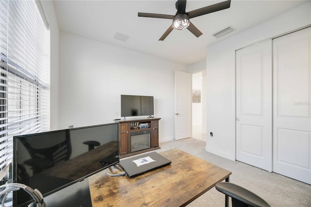 carpeted living room with ceiling fan