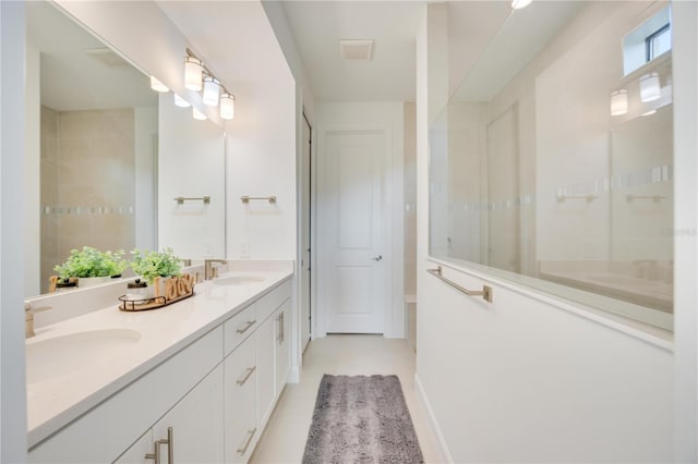 bathroom featuring vanity and tiled shower