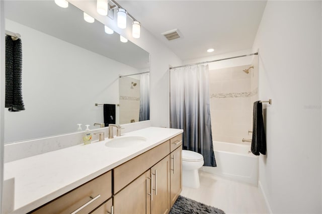 full bathroom featuring vanity, shower / tub combo, and toilet