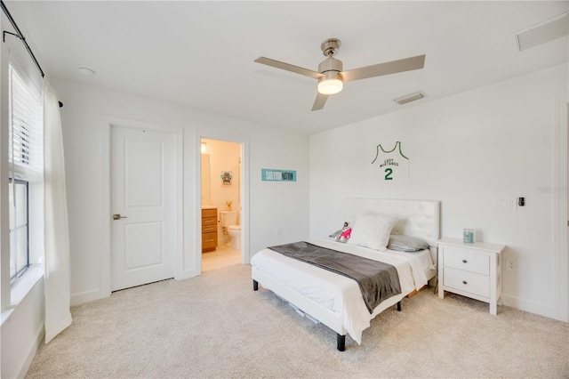 bedroom featuring ensuite bath, ceiling fan, and light colored carpet