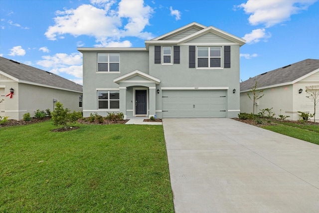 view of property featuring a garage and a front lawn