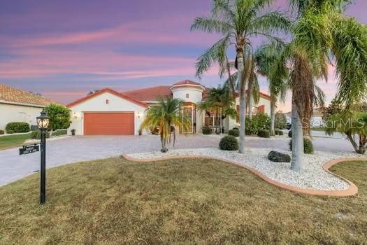 view of front of home with a lawn and a garage