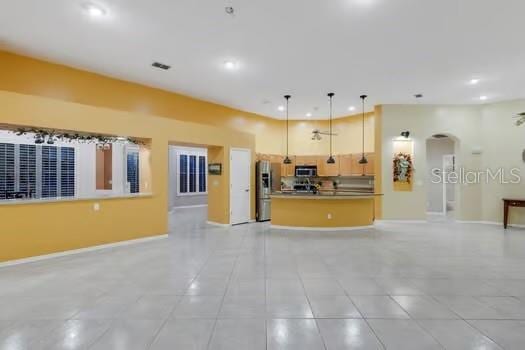 kitchen with light tile patterned floors, pendant lighting, and appliances with stainless steel finishes