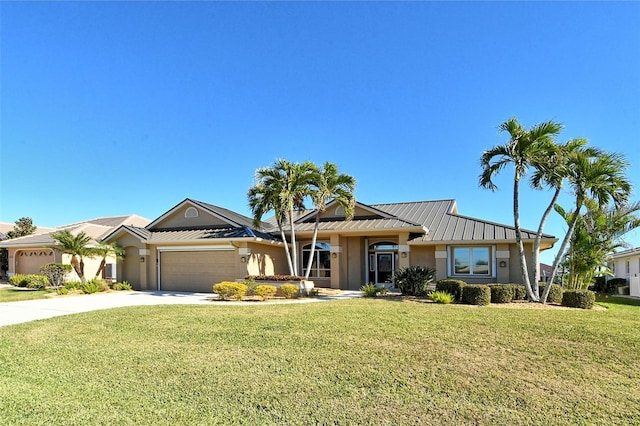 ranch-style house featuring a front yard and a garage