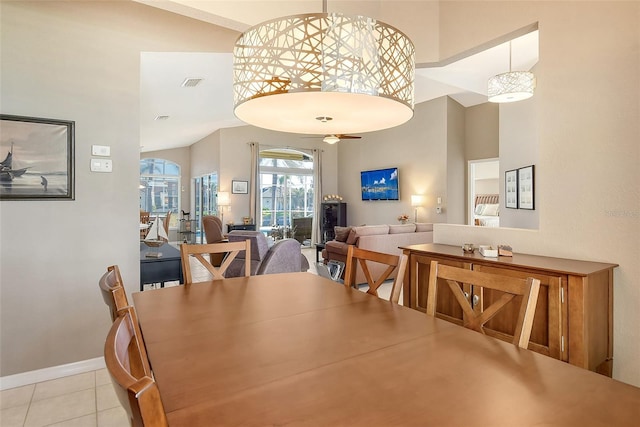 dining space with light tile patterned floors and ceiling fan