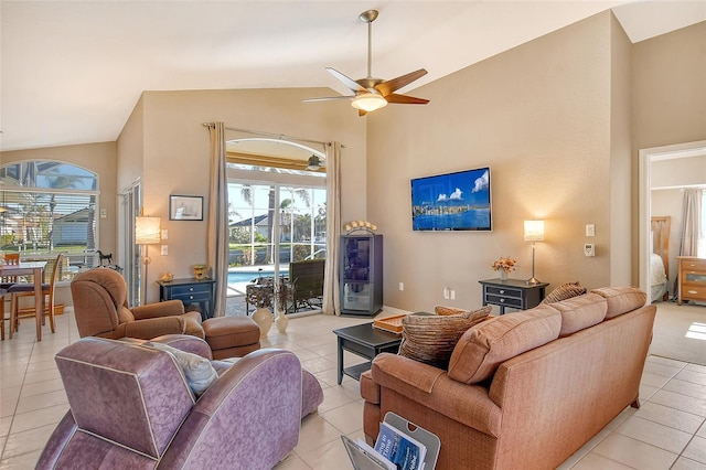 living room with ceiling fan, light tile patterned floors, and high vaulted ceiling