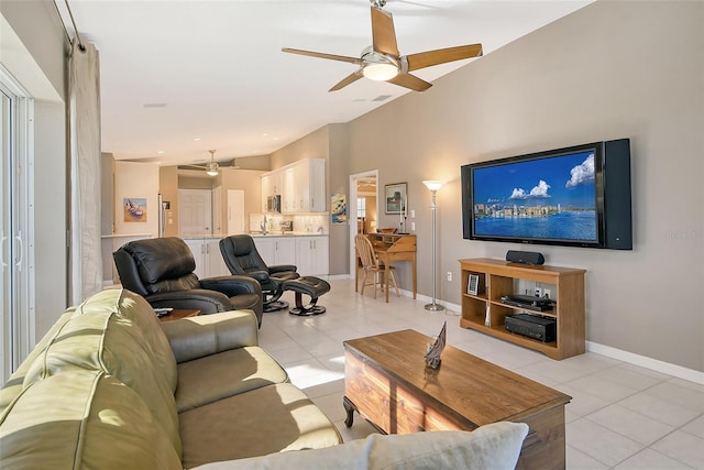 tiled living room featuring vaulted ceiling, ceiling fan, and sink