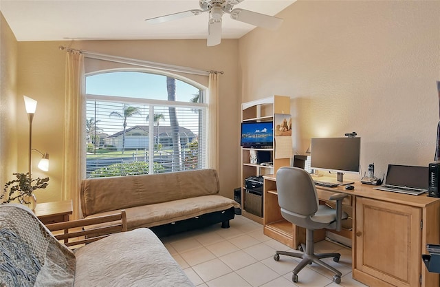 office featuring ceiling fan, lofted ceiling, and light tile patterned floors