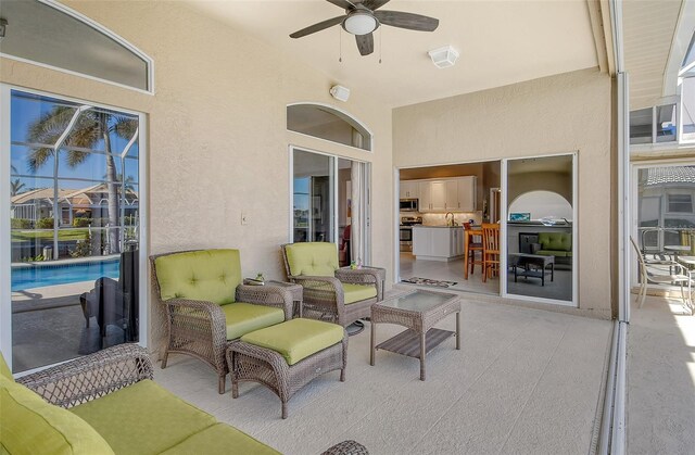 view of patio featuring ceiling fan