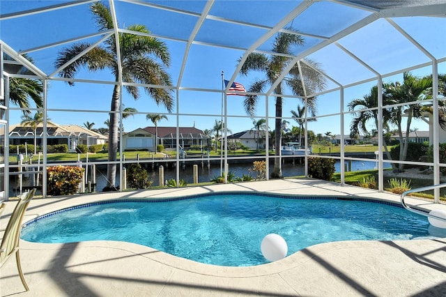 view of swimming pool featuring a patio, a water view, and a lanai