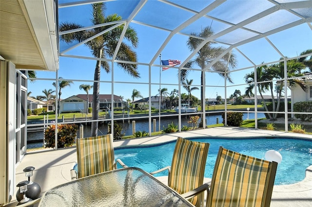 view of swimming pool with a water view, a patio area, and a lanai