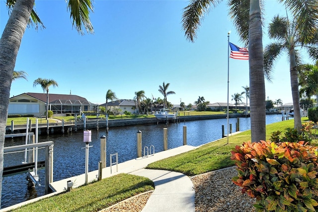 dock area featuring a yard and a water view