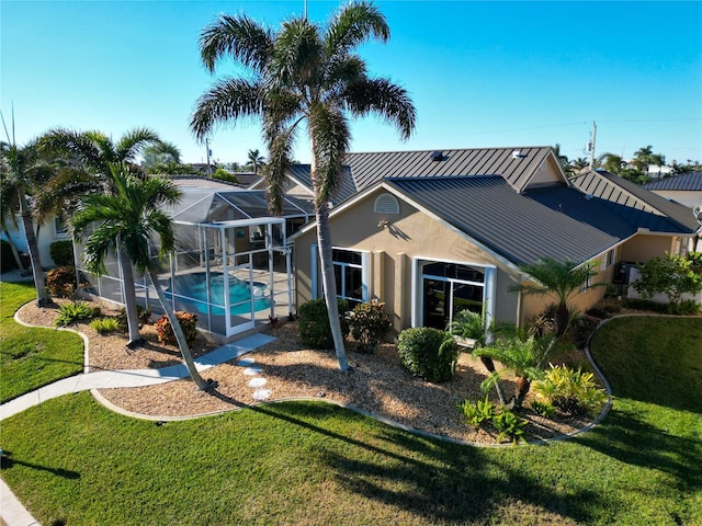 exterior space with a lawn and a lanai