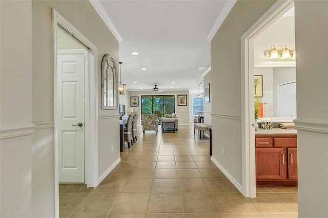 hallway with crown molding and light tile patterned flooring