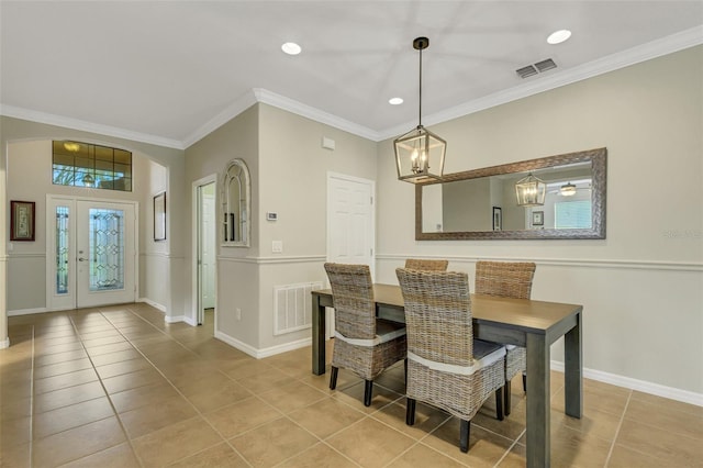 tiled dining area with a notable chandelier and crown molding