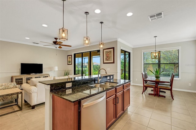 kitchen with sink, stainless steel dishwasher, dark stone counters, pendant lighting, and a kitchen island with sink