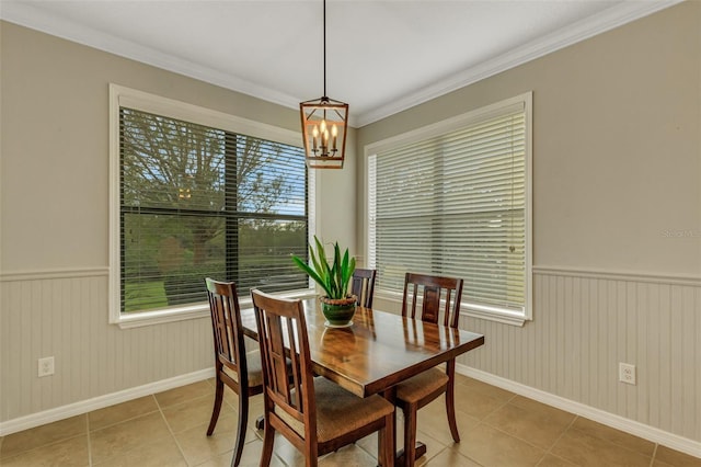 dining space featuring crown molding, plenty of natural light, and light tile patterned floors