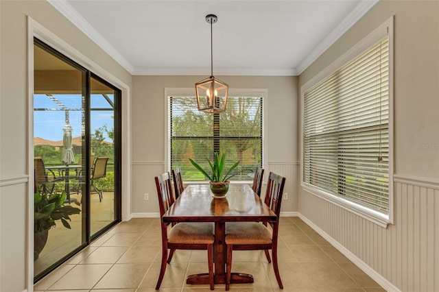 tiled dining area featuring a chandelier, plenty of natural light, and crown molding